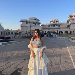A beautiful white lehenga with a sparkling silver blouse, styled for an elegant day wedding or a festive event.