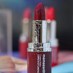For cosmetic brands, I focus on creating a luxurious feel. This close-up of a Mamaearth matte lipstick, covered in fine water droplets, emphasizes its rich color and hydrating quality against a soft, dreamy background.