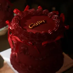 Another look at our Cartier-inspired cake, showcasing the deep red frosting and intricate piping that give it such a luxurious feel.