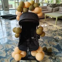 It's the small details that make a big difference. To complete the grand entrance for the birthday baby, I decorated their stroller with matching balloons, ensuring even the littlest guest of honor arrived in style.