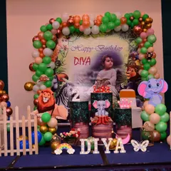 A closer look at a jungle safari theme, showing the detailed pedestals, animal cutouts, and a custom backdrop. I can arrange these elements to fit different venue sizes for your kid's birthday party.