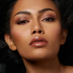 Stunning glam on point. This look, created by a student for her first-ever portfolio shoot, features a beautiful soft brown smokey eye and glowing skin.