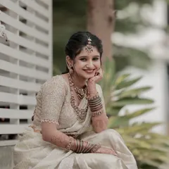 A beautiful, happy portrait of Ramya, the sister of the bride. Her makeup is soft and radiant, perfect for a daytime wedding event.