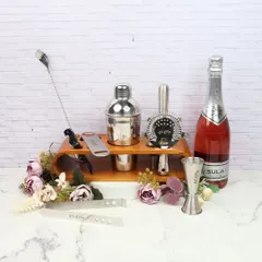 Elevate your home bar with this luxe bar set. It includes a cocktail shaker, strainer, jigger, and other essential tools, all neatly organized on a wooden stand. It's a perfect gift for any cocktail enthusiast.