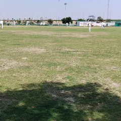 A view of our main cricket ground during a weekly practice match. We have a lush, well-maintained grass field to ensure you get experience in real match conditions, which is a core part of our residential program.