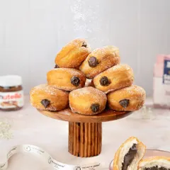 A tower of our classic Berliners, generously filled with rich chocolate and dusted with powdered sugar. These pillowy soft donuts are an irresistible treat.
