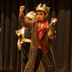 Embodying royalty in 'The Emperor's New Clothes'. This young actor demonstrates powerful posture and character expression, key performance skills we develop to help children communicate personality and status on stage.