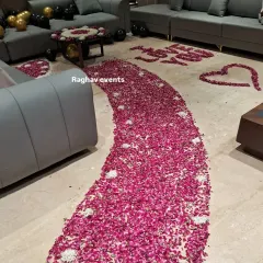 A closer look at the detailed floor work for a romantic surprise. I create a thick, curved pathway of fresh rose petals, along with heart shapes and messages like "I LOVE YOU" written with flowers.