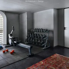 The home gym in Project 86, featuring a dedicated area for weights and cardio. The design is clean and motivating, with a classic Persian rug to add an unexpected touch of warmth.