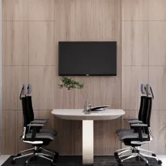 A minimalist meeting nook within a modern office. The clean lines, wood paneling, and ergonomic chairs create a professional and focused environment for collaboration.