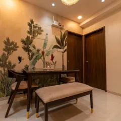 The dining area of the Pune home, where a nature-themed wallpaper creates a beautiful and intimate setting.