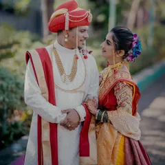 A classic portrait of a Maharashtrian couple. The groom in his 'pheta' and the bride in her traditional saree share a look of love, a timeless moment from their 'lagn'.