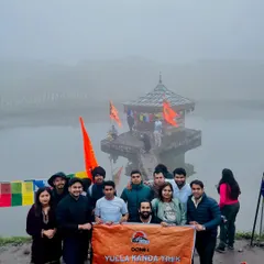 Our team at the Yulla Kanda trek, standing before the world's highest Krishna temple situated by a serene lake. A truly spiritual journey.