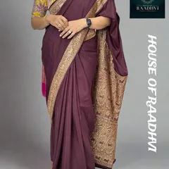 A full view of our restocked dark brown Banarasi saree. This budget-friendly option offers a rich, traditional look and is paired here with a contrasting floral blouse to show its versatility.