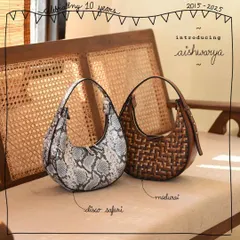 The Aishwarya bag, named after one of our patrons, is shown here in two stunningly different artistic edits. On the left, the bold Disco Safari print makes a modern statement, while on the right, the classic tri-color Madurai weave offers a timeless, textured look.