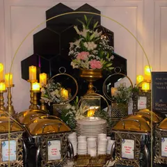 The details define the luxury. Our signature buffet tablescapes feature elegant floral arrangements, warm candlelight, and polished gold chafing dishes, creating an atmosphere of opulence and refined taste for your guests.