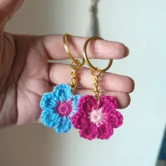 We offer our floral keychains in many color combinations. This pair shows a blue and pink one next to a magenta and pink one, perfect for coordinating with friends.
