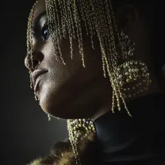 A dramatic close-up for Reasons Jewellery, using shadow and light to highlight the intricate details of the headpiece and earrings.
