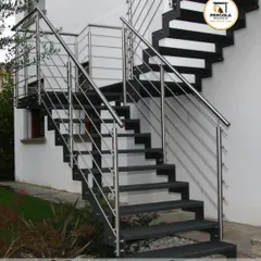 A modern exterior staircase combining a strong black metal frame with sleek stainless steel cable railings. This design offers a contemporary and minimalist aesthetic while ensuring safety and durability.