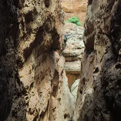 A climber navigates a narrow chimney route in Badami, a classic feature of the area. This demonstrates the variety of climbing styles covered in our advanced course.