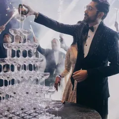 The groom kicks off the celebration with a champagne tower, a classic and glamorous moment that signals the start of a fun-filled cocktail night.