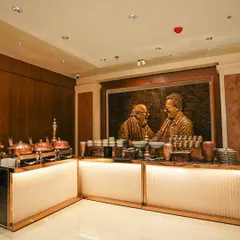 An indoor buffet arrangement featuring our signature copper chafing dishes against a backdrop of rich wood paneling. This setup is ideal for formal boardroom dinners and corporate functions, offering a touch of classic elegance.