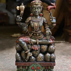 A unique 25.5-inch sculpture of Lord Mahadev (Shiva) seated on stones. The dark green antique finish gives this handcrafted piece a mystical and ancient feel, perfect for a pooja room.