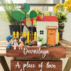 A home is a place of love, hope, and dreams. This nameplate captures that feeling with a sweet family scene and a second hanging plaque for a favorite quote. The details, from the tiny house to the kissing couple miniatures, make it a truly personal piece.