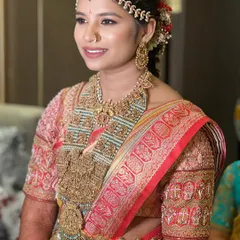 A smiling portrait of the bride, her happiness evident. The makeup is classic and timeless, perfect for her special day.