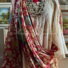 A truly regal statement, this Chikankari tissue chanderi Anarkali is draped with a magnificent Srikalahasti Kalamkari dupatta. The hand-painted peacock motifs on a deep maroon base evoke a sense of heritage and grandeur, perfect for the most special occasions.