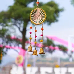 A close up of a handcrafted dreamcatcher with bells, used as a hanging decor element. These small, detailed touches add a bohemian charm and are perfect for close up shots.