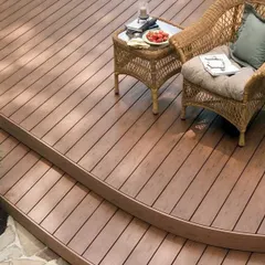 A curved, multi-level deck made from composite wood. The smooth, rounded edges create a soft, organic flow and demonstrate our ability to create complex, custom shapes.