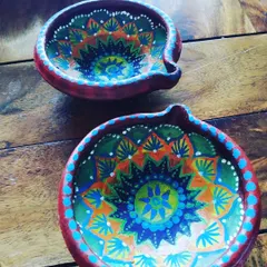 Here are two of my hand-painted terracotta diyas, perfect for Diwali. I use bright acrylic paints to create detailed mandala patterns, ensuring each piece is a unique work of art for your festive celebrations.