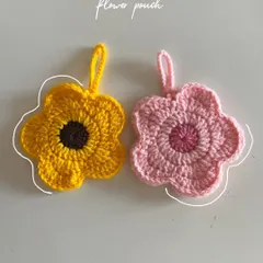 My little flower pouches are perfect for keeping small treasures safe. This side-by-side shot shows the sunflower and pink daisy designs. They are great for holding jewelry, lip balm, or even your AirPods.