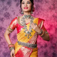 A classic bridal portrait against a colorful studio backdrop. The model is adorned in heavy silver jewelry and a traditional silk saree, and my goal was to capture a look of grace and confidence.