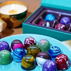 A close-up shot of artisanal bonbon chocolates, highlighting their vibrant colors and intricate designs. This kind of detailed food photography is perfect for luxury confectionary brands looking to showcase the quality of their products.
