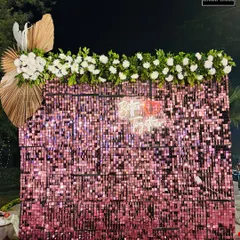 Another view of the sparkling pink sequin photo wall. The shimmering tiles catch the light beautifully, creating a dynamic and eye-catching backdrop for any celebration.