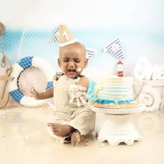 Even a little sailor needs a cake break. This little one wasn't quite sure what to make of his first birthday cake, making for some truly adorable and funny expressions.
