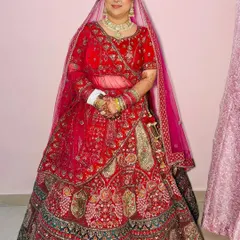 The complete bridal look. This stunning red lehenga is perfectly complemented by the timeless makeup and jewelry, creating a regal and elegant appearance for her wedding day in Ghaziabad.
