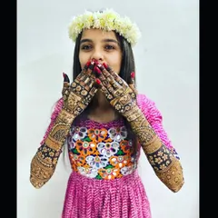 A playful moment with a happy bride. Her intricate mehndi design is the perfect accessory for her fun and festive spirit.