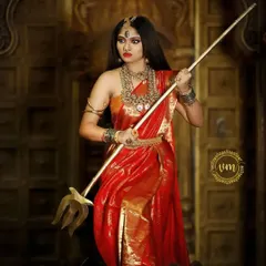 A full-length shot of the Devi look, showcasing the grandeur of the red saree and the complete set of our imitation temple jewellery.