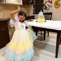 Here is the birthday girl with her magical three-tier unicorn cake. Seeing her joy was the best part of creating this special, multi-layered masterpiece.