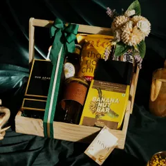 This hamper was specially curated for Rakshabandhan but is a great example of a personalized gift for him. It includes a mix of luxury and practical items like Oud Arabia perfume, a travel wallet, a glass coffee tumbler, and gourmet snacks.