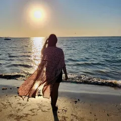 Chasing sunsets on the beach. A lightweight, printed shrug over a simple dress is the perfect outfit for a breezy evening by the sea. It's all about effortless, romantic style.