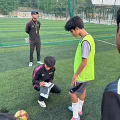 A coach provides individual feedback during a training session. We focus on personalized development to fine-tune each player's skills.