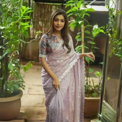 A delicate lavender georgette saree with all-over sequin work and a lace border. This is a dreamy and romantic piece, perfect for an evening celebration.