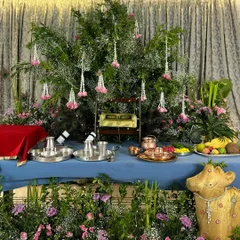 We created a lush, garden-like setting for this Janmashtami celebration, using a canopy of fresh greenery, hanging floral strings, and a traditional swing (jhoola) for Lord Krishna.