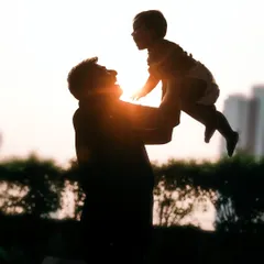 There's something so powerful about a father lifting his child to the sky. This silhouette against the sunset captures that feeling of strength, love, and endless possibility in a single, artistic frame.