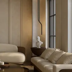 Natural light plays a crucial role in our designs. In this space, sunlight streams in, highlighting the soft textures of the furniture and the classical bust, creating a corner that feels both sophisticated and serene.