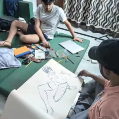 A behind-the-scenes look at a live sketching session in our studio. I am demonstrating how to create a quick figure drawing with bold ink lines, focusing on capturing the pose and energy of the model.